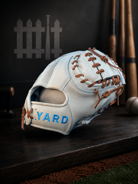 Baseball glove with 'Yard' branding on a wooden surface with bats in the background