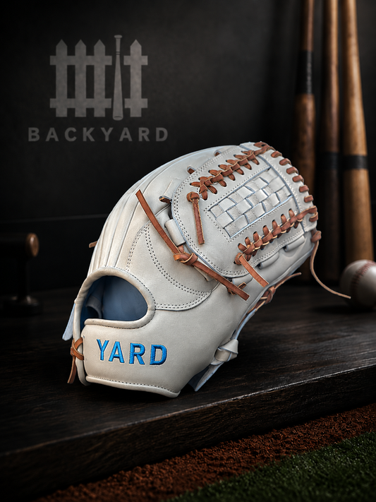 Baseball glove with 'YARD' branding on a wooden surface, featuring the 'Backyard' logo.
